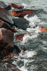waves hitting stones on the shore in the black sea during a storm - 384132209