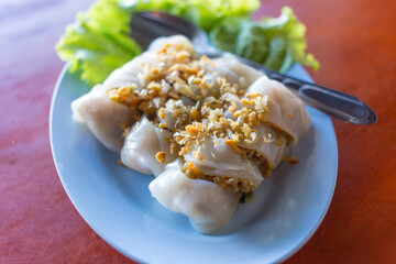 Noodle tubes is a Asian food which it contains pork and vegetables inside and fried garlic added on top.