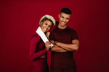 Smiling fitness couple standing together after workout