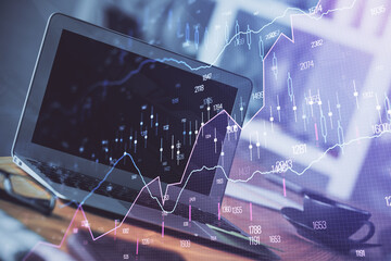 Forex market graph hologram and personal computer on background. Multi exposure. Concept of investment.