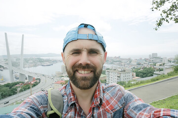 Vladivostok man bridge portrait, a man in a tourist cap in Russia
