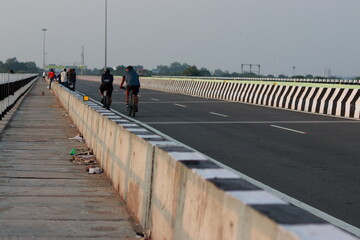Chennai TamilnaduI , India. Oct 07, 2020. I A crowd of people gathered on the road built on the river bridge and some players cycled.