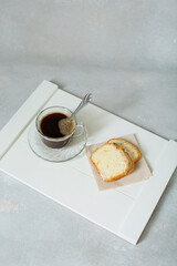 pieces of cut cake for breakfast on a tray and a cup of aromatic coffee. top view