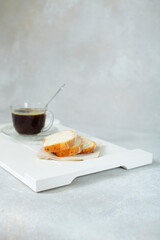 pieces of cut cake for breakfast on a tray and a cup of aromatic coffee. side view