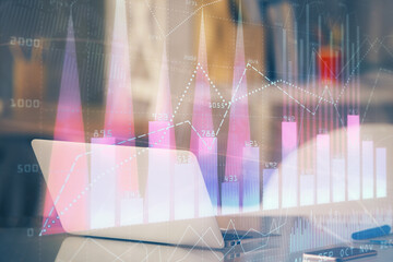 Stock market graph and table with computer background. Double exposure. Concept of financial analysis.