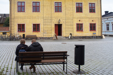 Couple Sitting By The Town Hall