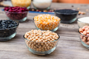 Soybean or soya bean in a bowl on wooden background. Soybean organic background.
