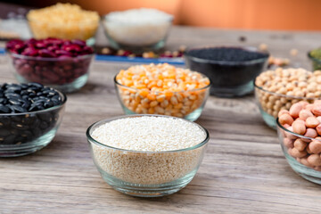 White sesame in bowl on wood table background. White sesame  seed in bowls.