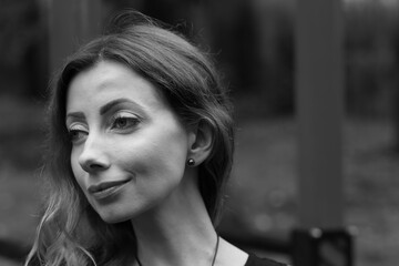 Portrait of beautiful woman outside in black and white