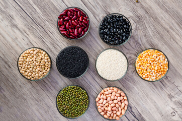 Cereal grains seeds beans on wooden background. Whole grains and bean. Cereals and beans. Different dry legumes for eating healthy. Peanut , Black bean, Red Bean. Green Bean, Soybean, sesame