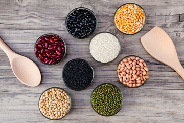 Fototapeta na wymiar Cereal grains seeds beans on wooden background. Whole grains and bean. Cereals and beans. Different dry legumes for eating healthy. Peanut , Black bean, Red Bean. Green Bean, Soybean, sesame