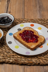 Breakfast. Peanut butter and jelly sandwich on wooden background.