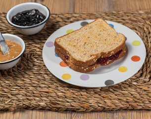 Fototapeta na wymiar Breakfast. Peanut butter and jelly sandwich on wooden background.