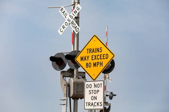 High speed train warning sign at railroad crossing. Concept of railroad crossing safety, danger and transportation industry
