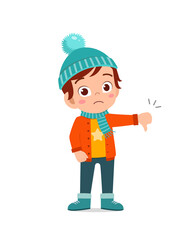 Obraz na płótnie Canvas happy cute little feel disappointed and wear jacket in winter season. child use thumb down and wearing warm clothes