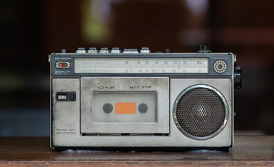 vintage stereo cassette recorder on wooden table. retro radio tuner.