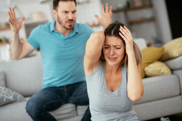 Fototapeta premium Violence in family. Husband beating his wife...
