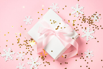 Christmas flat lay background with christmas present box on pink.