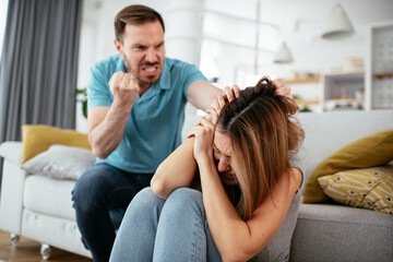 Obraz na płótnie Canvas Violence in family. Husband beating his wife...