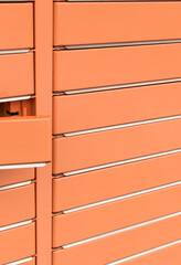 Post office box, the door is open. Orange post box for rentals.