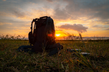 bagpack and drone with sun set