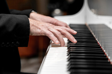 Fototapeta na wymiar Caucasian male playing a grand piano