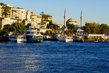 Fototapeta na wymiar Istanbul, Bodrum - August 2020: Tour boats travel around the Bosphorus Canal on clear summer days. Bosphorus Sunset Cruise, Sultanahmet, 