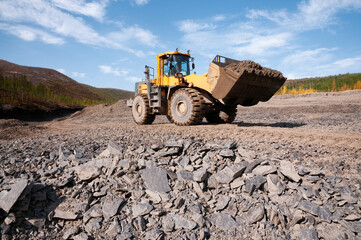 Wheel loader during earthworks in mountainous area - Mining