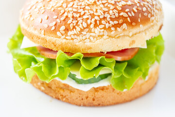 Burger with lettuce and sesame seed bun