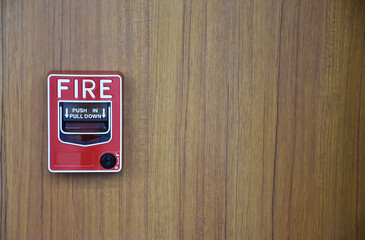 Fire alarm switch on the wood grain wall (with copy space).