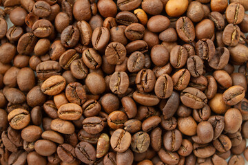 Dark brown Roasted coffee beans background, top view texture