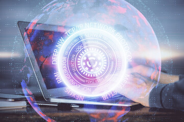 Technology theme hologram with man working on computer on background. High tech concept. Double exposure.