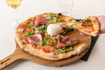 Pizza with mozzarella and raw ham