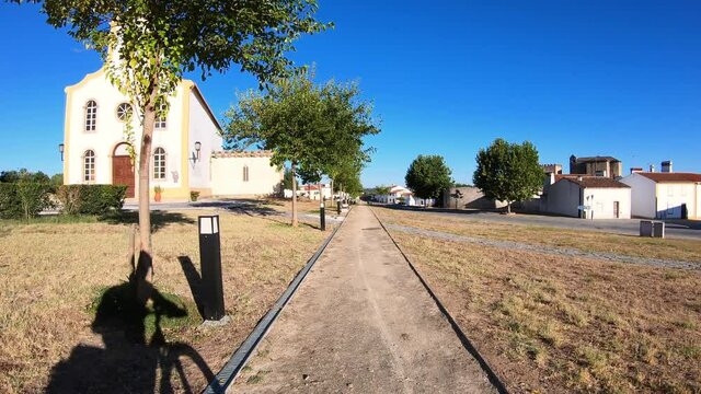 dolly move forward - shadow of a touring cyclist riding on a street at Flor da Rosa village, municipality of Crato, Portalegre district, Alentejo, Portugal