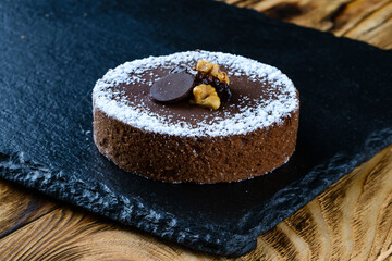 sweet tartlet dessert on a stone tray