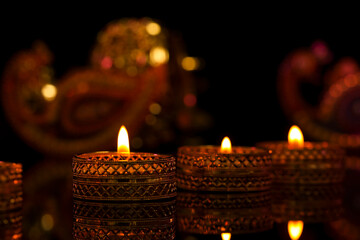 Indian festival diwali , candle on dark background
