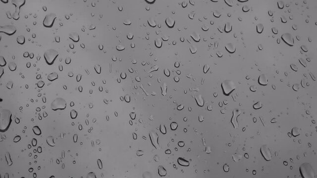 Raindrops on window pane. A gloomy day in autumn. Fall mood.