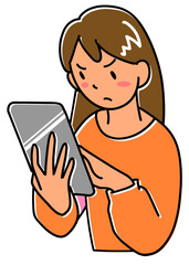 不機嫌な顔でタブレットを見る若い女性