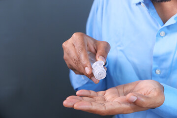 close up of young man hand using sanitizer gel for preventing virus 