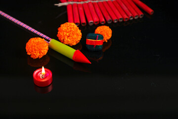 Diwali Diya with Fire Crackers over rangoli background