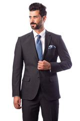 A young man wearing a black suit on a white background