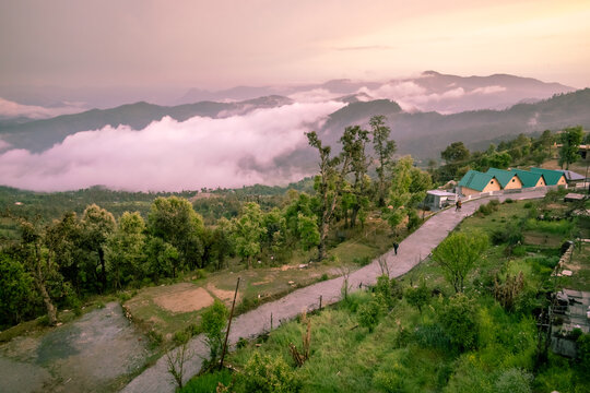Dramatic landscape of a road passing through misty hills