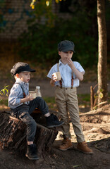 Boys snacking on bread and milk on a stump in the forest