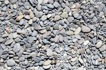 Stone pebbles on the sea as an abstract background.