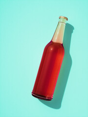 Single transparent glass bottle laying on light blue background.