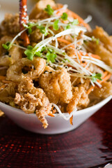 Calamari served with spicy and sweet dipping sauces. Classic American restaurant or French bistro appetizer favorite. Fresh octopus, squid and shrimp battered and deed fried.