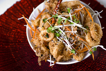 Calamari served with spicy and sweet dipping sauces. Classic American restaurant or French bistro appetizer favorite. Fresh octopus, squid and shrimp battered and deed fried.