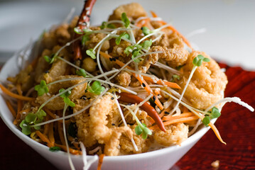 Calamari served with spicy and sweet dipping sauces. Classic American restaurant or French bistro appetizer favorite. Fresh octopus, squid and shrimp battered and deed fried.