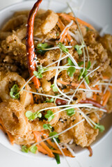 Calamari served with spicy and sweet dipping sauces. Classic American restaurant or French bistro appetizer favorite. Fresh octopus, squid and shrimp battered and deed fried.