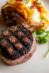 Steak. Grass-fed skirt steak, grilled to a medium rare and served with a garlic herb butter sauce and paired with roasted potatoes and Brussels sprouts. Classic American steakhouse favorite.